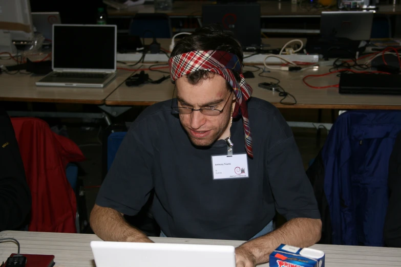 a man working on a laptop computer in an office