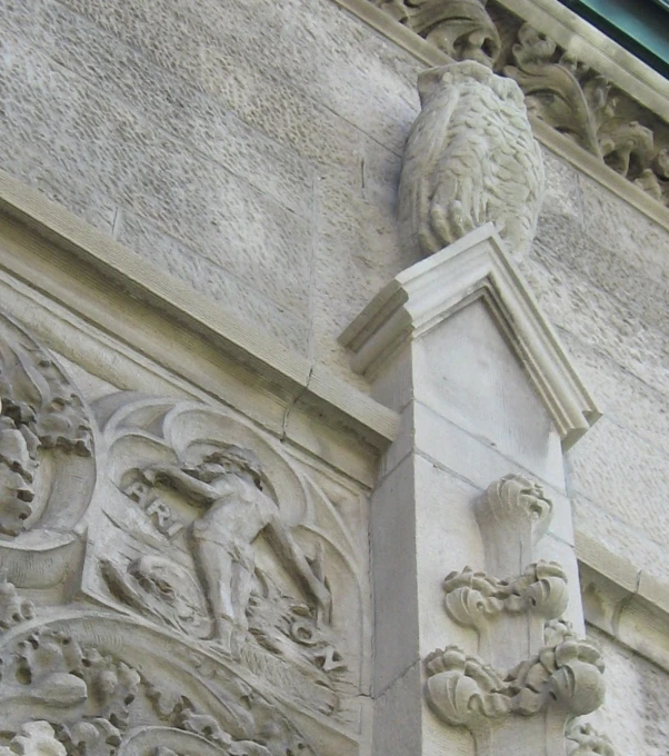 an intricate carving adorns the front of a building