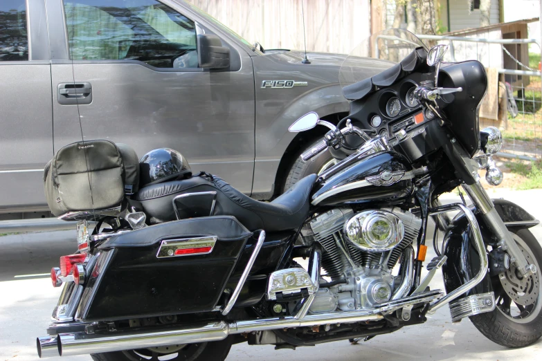 a motorcycle is parked next to a gray truck