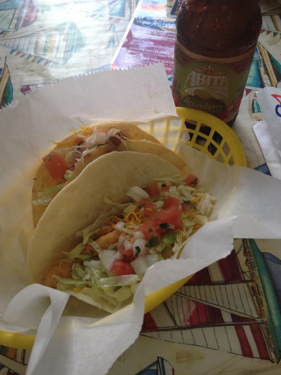 two tacos, one with sauerkraut and other with salsa and lime are on the table