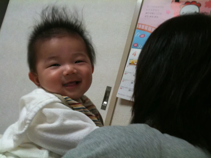 a baby that is laughing and a woman