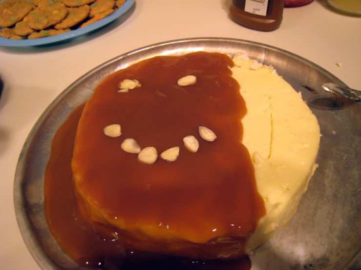 cake with the letter b in the shape of a face sitting on a pan