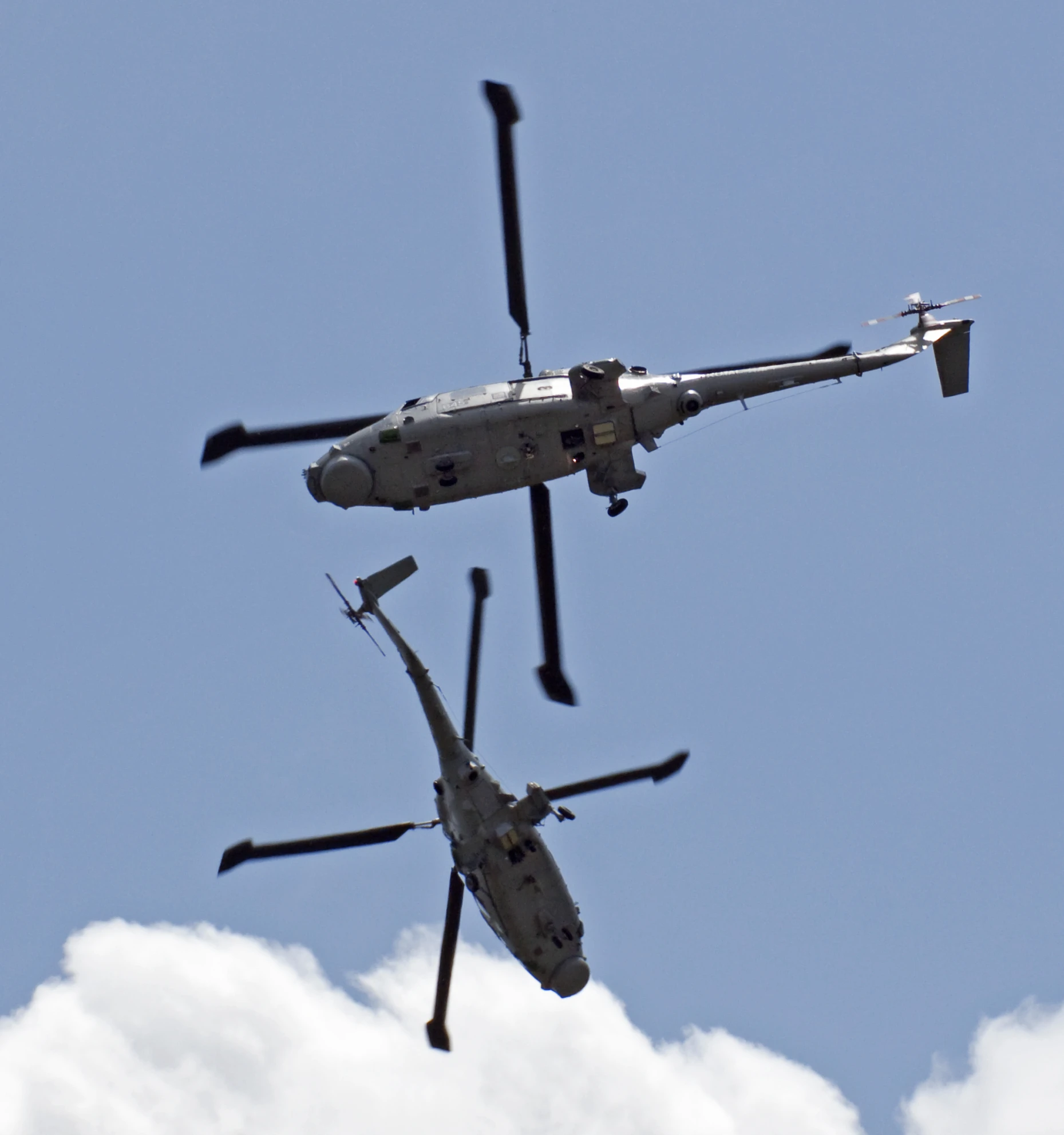 a pair of helicopter flying high in the sky