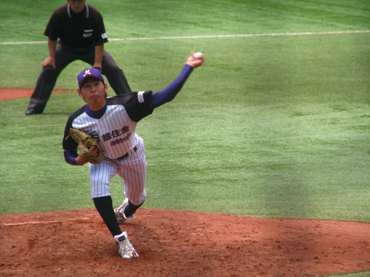 a professional baseball player is on the field with his arm raised in the air