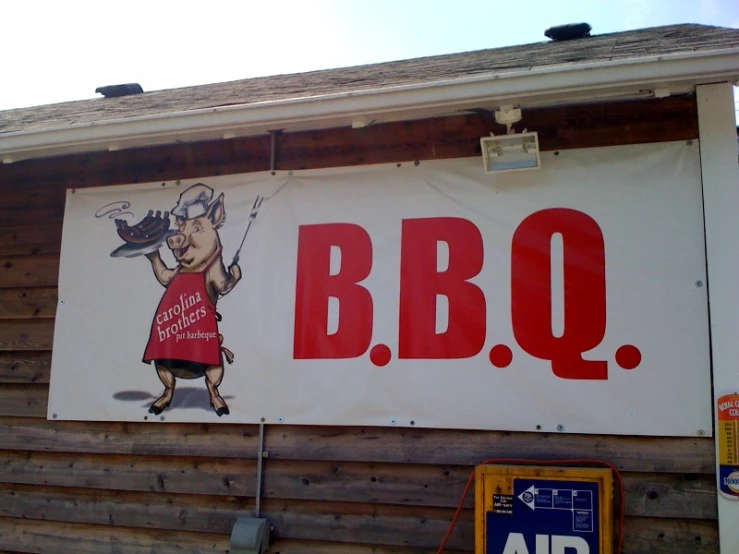 a large sign with an advertit on it says bbq