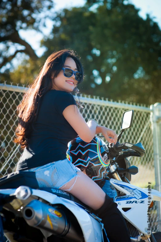 a  with sunglasses sitting on a motorbike