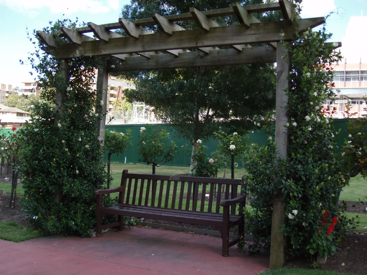 a bench under a pergola type covered gazebo