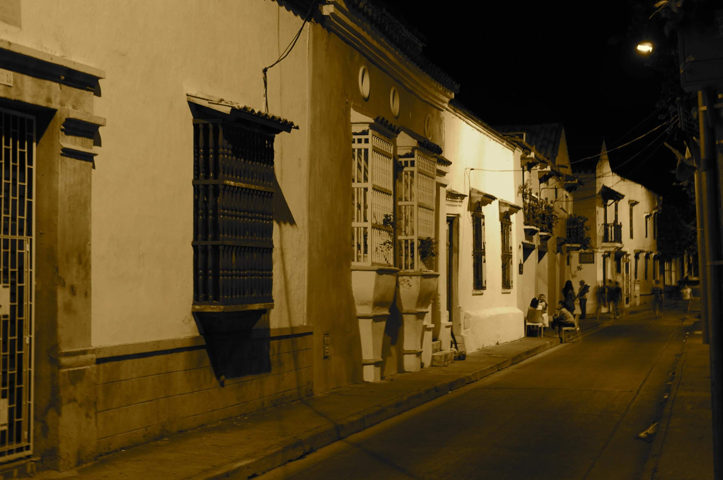 a city street at night with buildings and windows