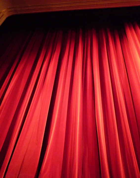 an open curtain in a theater with lights