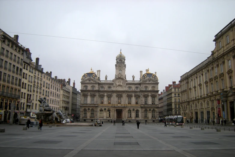 two large stone buildings with a tower clock on top