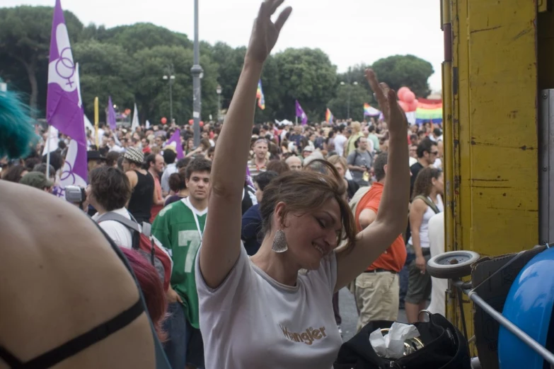 people at an outdoor concert with their hands in the air