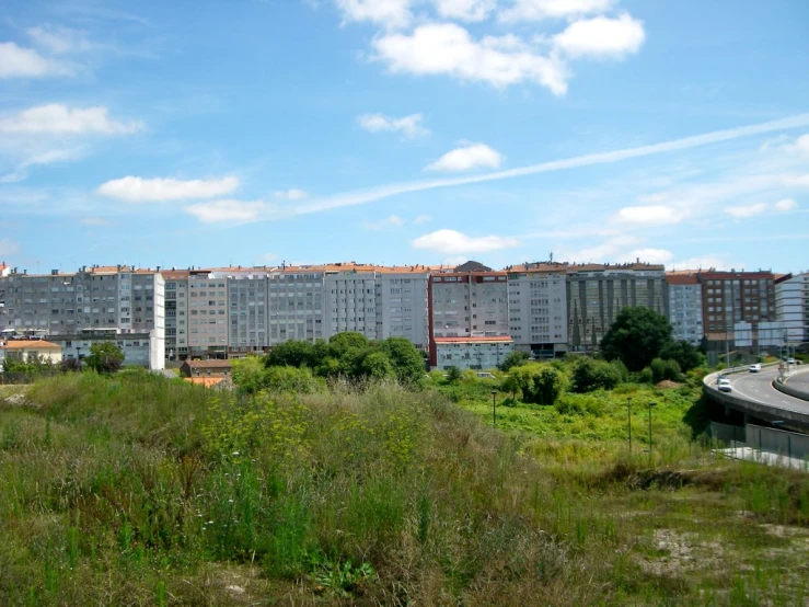 a group of buildings in the background with a parking lot in the foreground