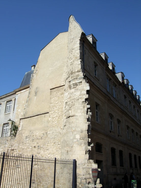 a very tall building with an iron fence around it