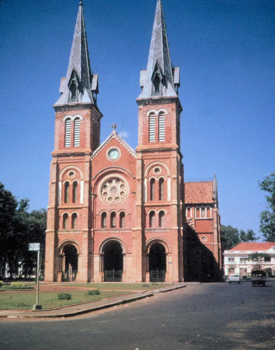 a large red brick building with two tall towers
