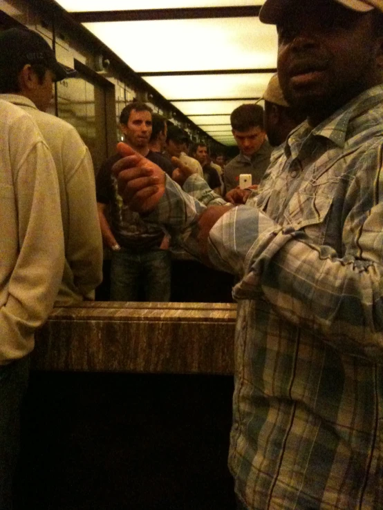 a group of men waiting at the subway