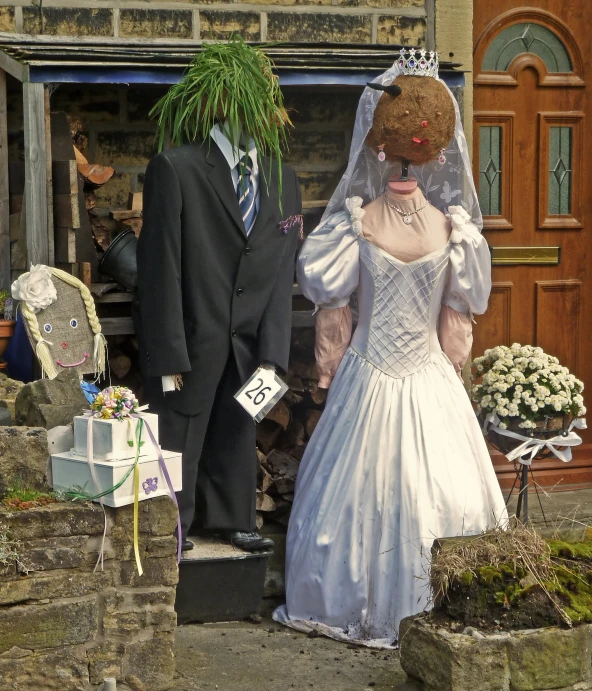 a scared up bride and groom standing beside each other outside a house