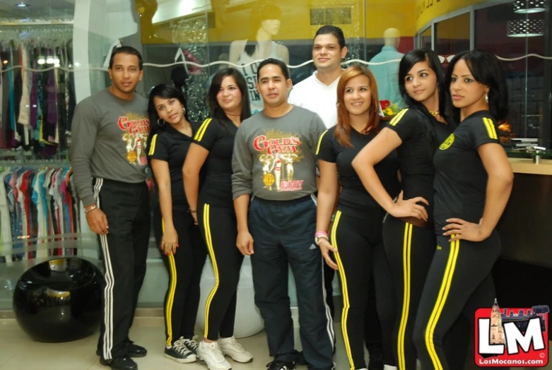 a group of young people standing together in front of a store