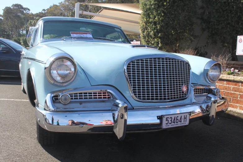 an old car parked on the side of the street