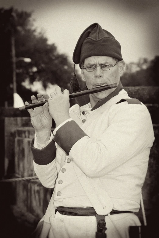 a person in uniform is playing the pipe