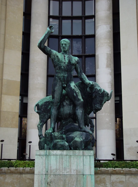 a sculpture in front of some large building