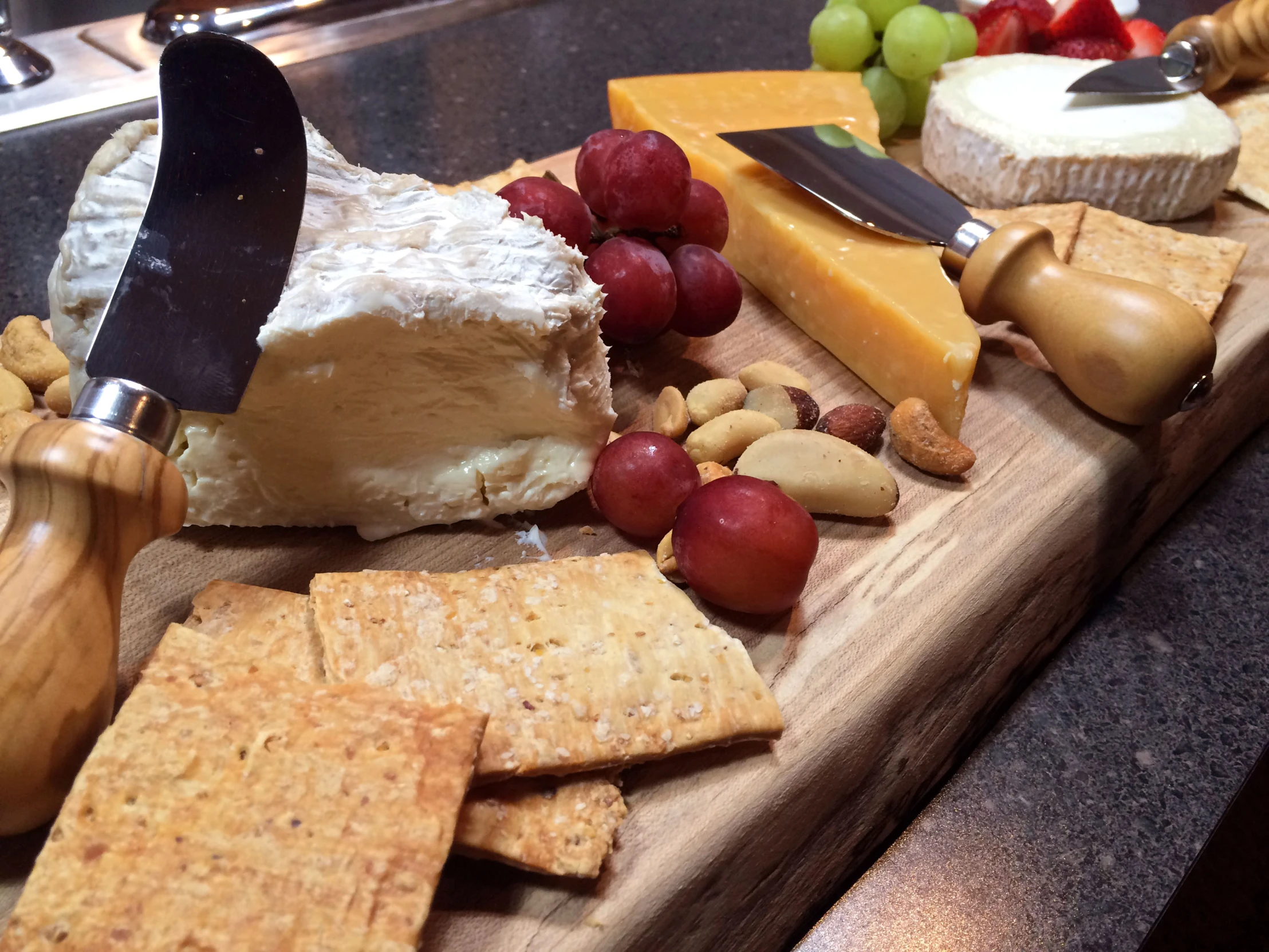 various types of cheese, ers and gs on a  board