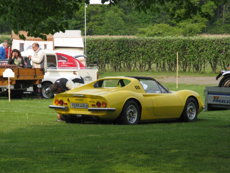 a vintage sports car being towed by another car