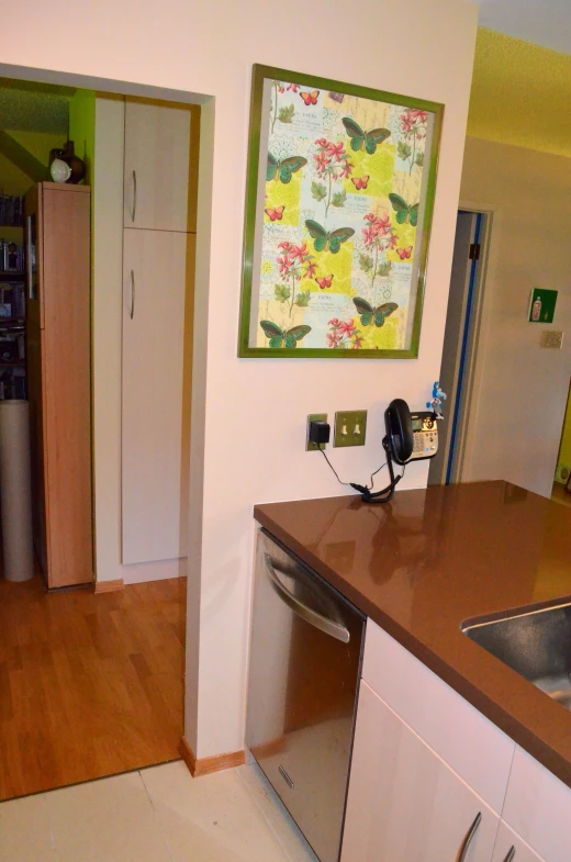 kitchen and living room with wood flooring and white cabinets