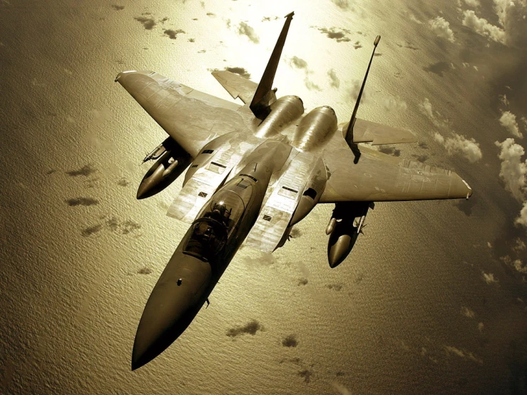 a silver fighter jet flying through a sky