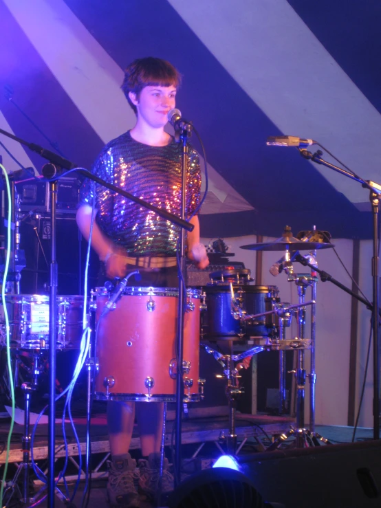 a person standing in front of two drums
