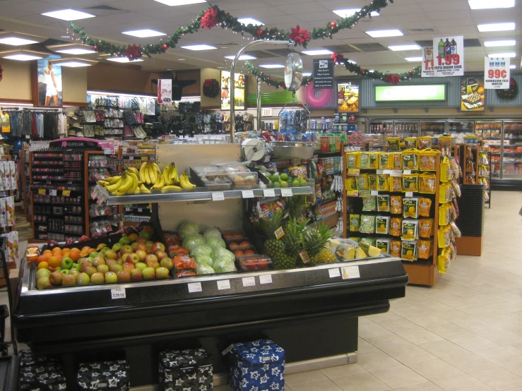 a produce section at a supermarket with hanging lights
