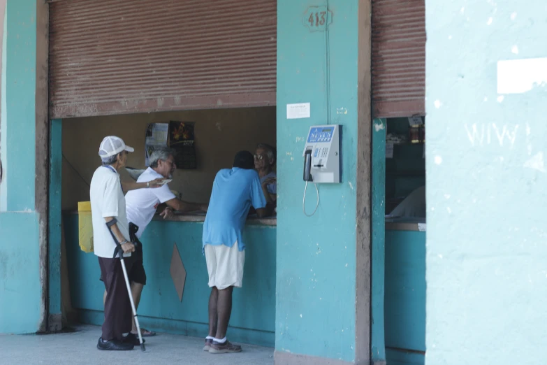 people looking at some food from an outside counter