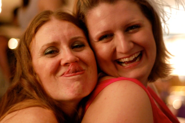 two women hug each other close up with their noses