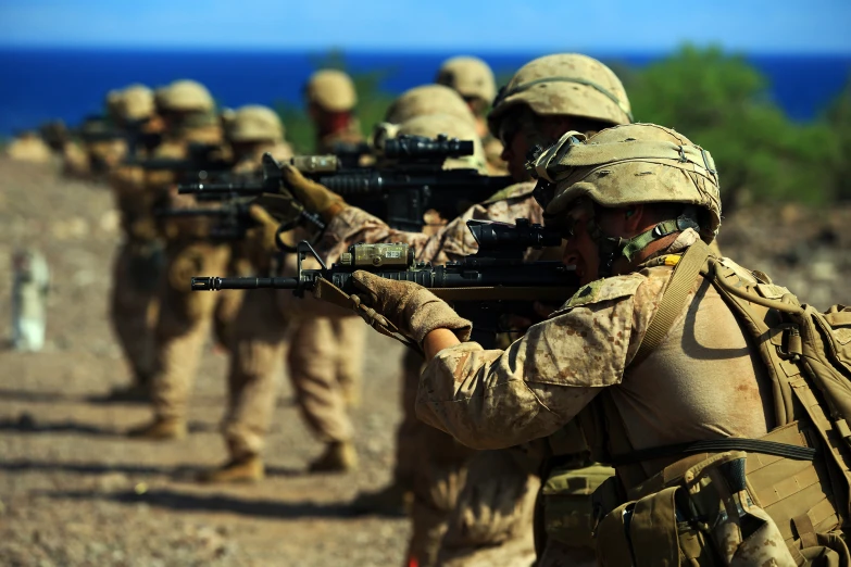 a group of men holding guns while on a desert field