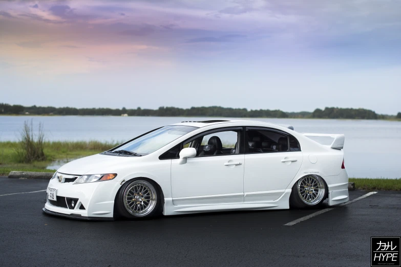 a white honda civic with 22 inch wheels