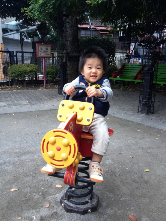 a  sitting on top of a small wooden toy train