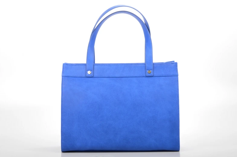 a bright blue handbag is shown on a white surface