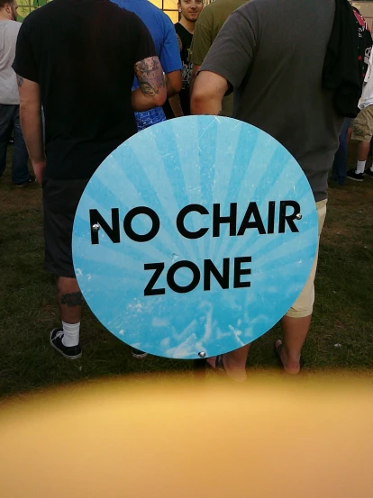 a no chair zone sign on display at a gathering