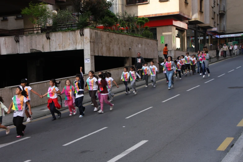 a group of people running down a road