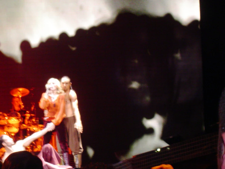 a group of people with white hair on stage