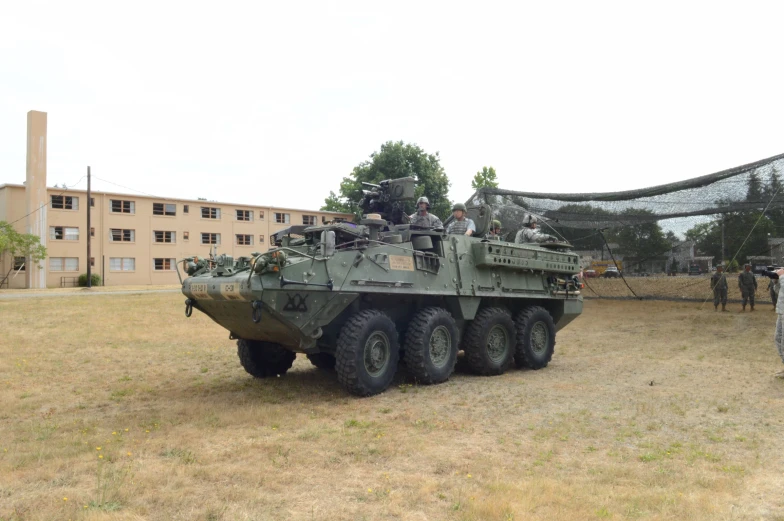 a vehicle with people riding on it in the field