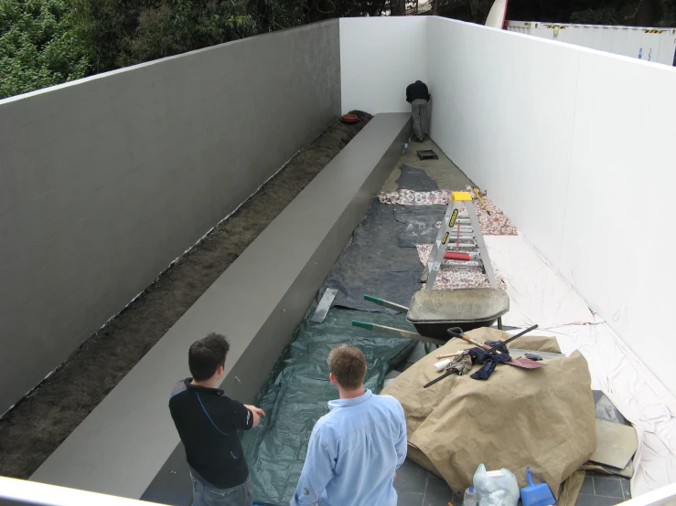 two young men building a back yard area for an outdoor kitchen