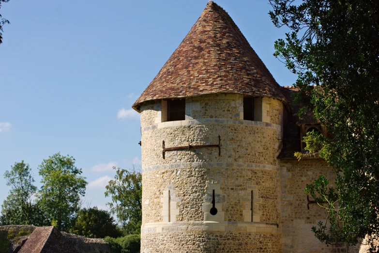 an old stone house with a face and roof