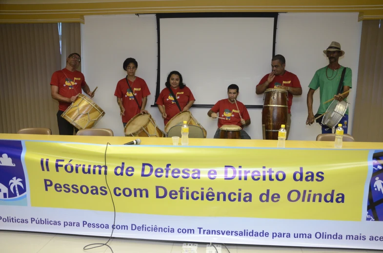 a group of people holding drums at an event