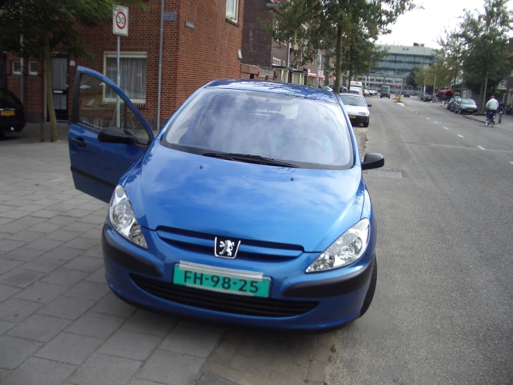 a blue van parked on the side of a road