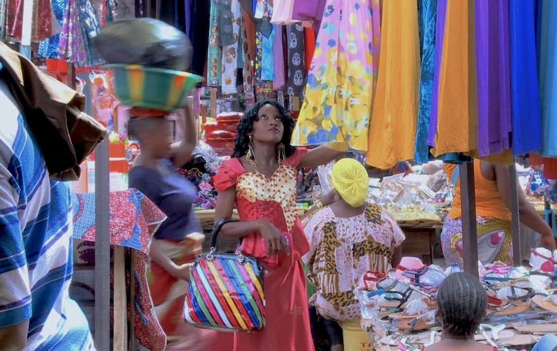 the lady is shopping at an outdoor market