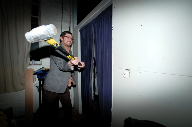 a man holding a blow dryer over his head