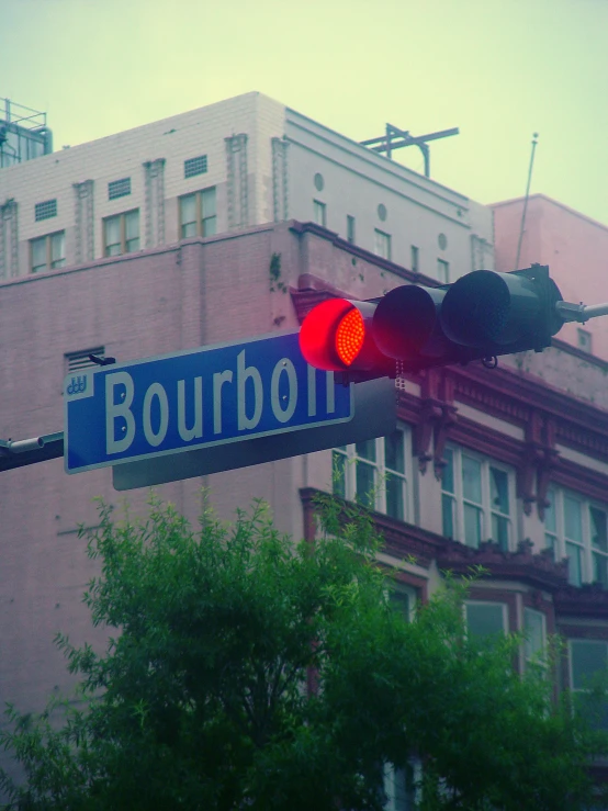 a street sign reads bourbon near a traffic light