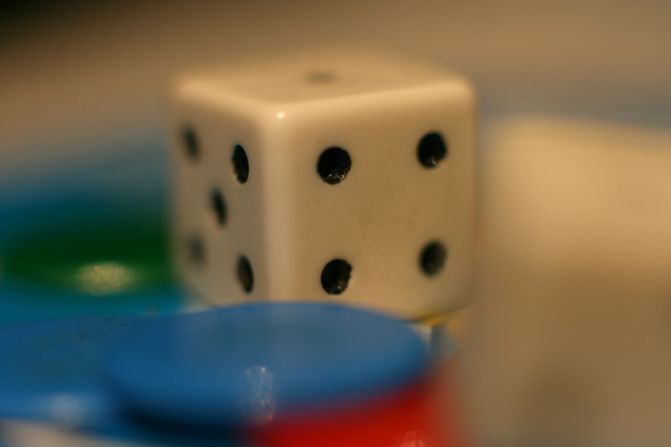 several dices, such as one dice and a red dice sit on the table