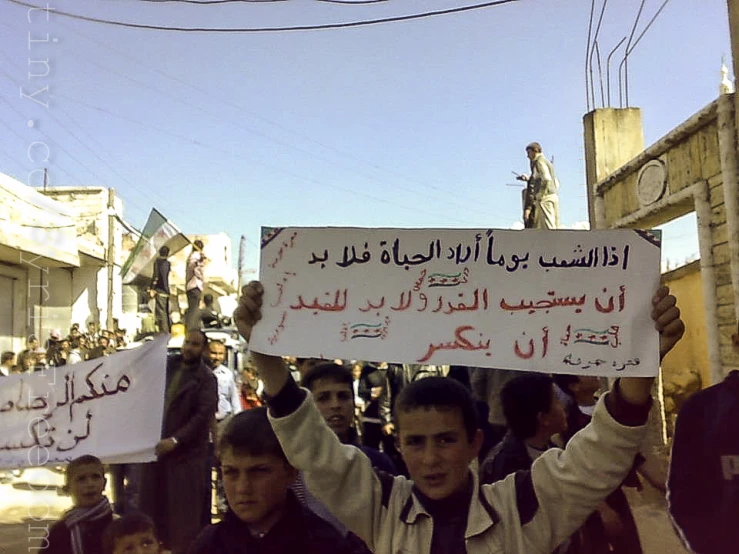 a group of boys holding signs in their hands