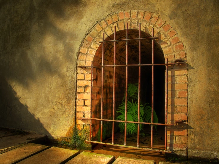 a large brick window that has bars on it